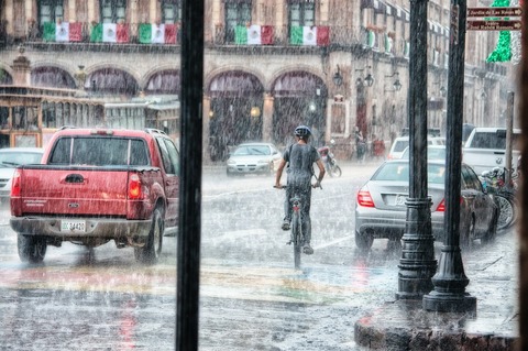 person-riding-a-bicycle-during-rainy-day-763398